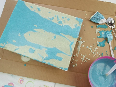 Allow excess sand paint to run off the edge of the canvas. Allow to dry overnight.